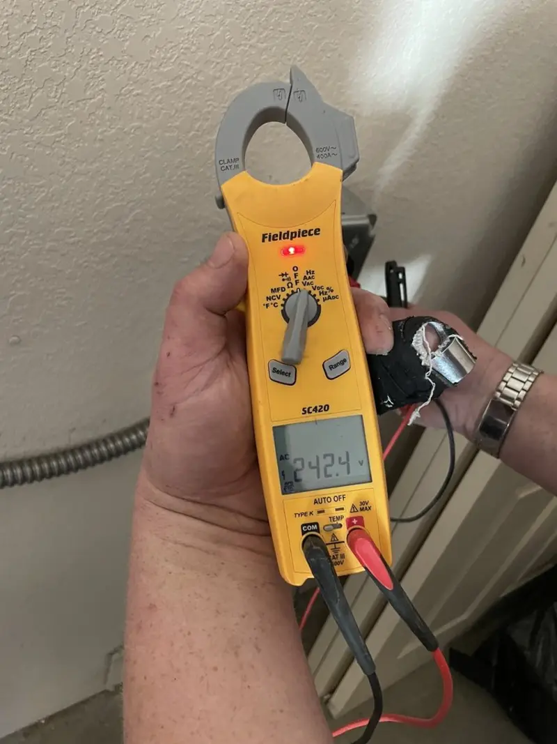 Voltage testing with clamp meter during Recessed Lighting Installation in North Palm Beach